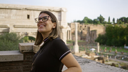 Young woman enjoying the scenic view at the historic roman forum in rome, italy, capturing a moment of cultural exploration and travel in europe.