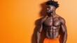 © JoxyAimages - A fit, muscular man stands shirtless against a bright orange backdrop, showcasing his physique. The image emphasizes strength and vibrancy with a modern aesthetic.