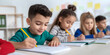 © SnapVault - A group of young children focus on writing in a bright modern classroom. Concentration and enthusiasm for learning while participating in this activity, fundamental literacy and academic growth.