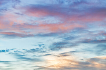 Wall Mural - A beautiful sky tinted by the sun leaving vibrant shades of gold, pink, blue and multicolored. Clouds in the twilight evening and morning sky. Cloudy sky background in the evening, and during the day.