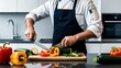© Oscar - Chef preparing fresh vegetables: A close-up shot of a chef expertly chopping colorful vegetables on a wooden cutting board in a modern kitchen