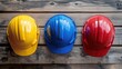 © DigitalDruid - A close up view of three vibrant construction helmets in red yellow and blue arranged on a wooden surface symbolizing safety and preparedness at a construction site