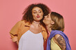 © Bliss - A joyful lgbt couple enjoys an affectionate moment against a bright pink backdrop.
