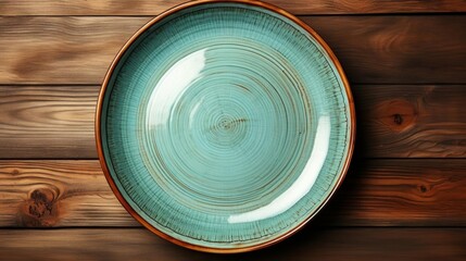 A blue plate with a brown rim sits on a wooden table