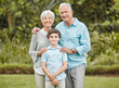 © peopleimages.com - Portrait, hug or boy in park with grandparents, smile and trust in nature, family or field together. Happy, senior grandma or grandfather in Australia with love or kid on outdoor holiday vacation