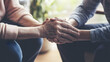 © Gita - elderly hand is gently held by a younger hand in a comforting gesture, symbolizing care, empathy, and support, with a softly lit background.