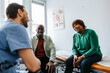 © Maskot - Mother and son sitting with male medical professional during visit in medical examination room