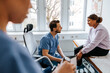 © Maskot - Young woman getting her leg examined by male medical expert in examination room