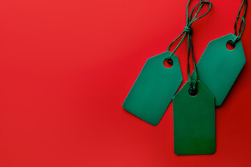 Minimalistic sale concept featuring green tags against a bold red background