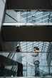 © Maskot - Low angle view of businesswomen discussing ideas while standing by glass railing