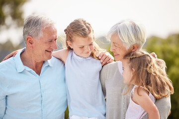 Canvas Print - Happy, park and children with grandparents in nature for bonding, relationship and relax together on weekend. Family, hug and grandpa, grandma and girls outdoors for playing, vacation and holiday