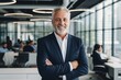 © CojanAI - Smiling portrait of a senior Caucasian businessman in modern office