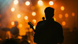 © Mahemud - Blurred background light on rock concert with silhouette of musicians.