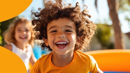 A cheerful child with curly hair beaming in a sunlit outdoor play area, alongside another child, epitomizing joy and carefree moments of childhood fun.