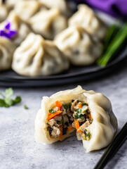 A close-up image of Chinese dumplings with one in the foreground split open to reveal its savory filling