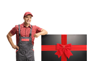 Repairman in a uniform standing next to a new tv set