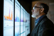© usman - Senior data analyst reviewing risk management reports on a large digital screen. high quality