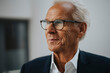 © Maskot - Senior businessman wearing eyeglasses in office