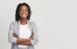 © Prostock-studio - Successful African Businesswoman With Arms Crossed On Grey Background, Free Space