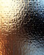 © AIGC JOE - An abstract close-up of textured glass, featuring a blend of warm orange and cool blue tones, creating a visually striking contrast with reflections and highlights.