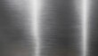 © Art and Illustration - Smooth brushed steel texture with intricate, sweeping brush patterns, illuminated to reveal a polished, industrial finish with depth