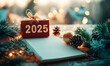 © VictoriaEmerson - A vibrant display celebrating the arrival of 2025 with twinkling lights, pinecones, and a notepad ready for fresh adventures