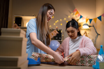 Two Asian women in room with Ciematic lighting celebrate important events such birthdays Christmas