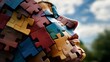 © milenialdesastudio - A close-up portrait of a person's face made of colorful jigsaw puzzle pieces against a blue sky.