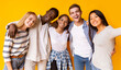 © Prostock-studio - Friendly international group of teenagers embracing and taking selfie over yellow background