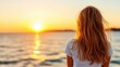© Lens Legacy - A girl stands quietly by the ocean shore, her hair flowing in the breeze as she watches a breathtaking sunset, conveying peace and introspection.