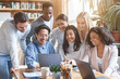 © Prostock-studio - Friendly young international team looking at laptop screen, watching business presentation at office