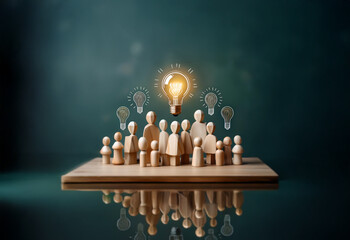 Poster - Wooden figurines stand in front of a large light bulb, representing the power of collective thinking.
