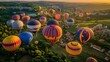 © Songsak - Colorful Hot Air Balloons Soaring Over Scenic Countryside at Sunrise with Rolling Hills and Lush Greenery