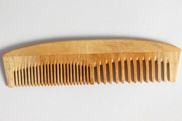 Close up shot of Wooden comb isolated with white background.