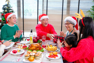 Wall Mural - Young woman and family having a Christmas party, Happy New Year.