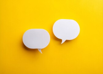 Bright yellow background featuring two white speech bubbles sparks creative design ideas and encourages engaging conversations through minimalist yet vibrant visual elements. Inspiration awaits!