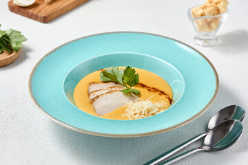 Wall Mural - Gourmet Pumpkin Cream Soup with Chicken and Parmesan in Elegant Composition