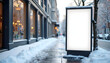 © Marina - Blank advertising display on snowy sidewalk in city with copy space and blurred pedestrians during winter
