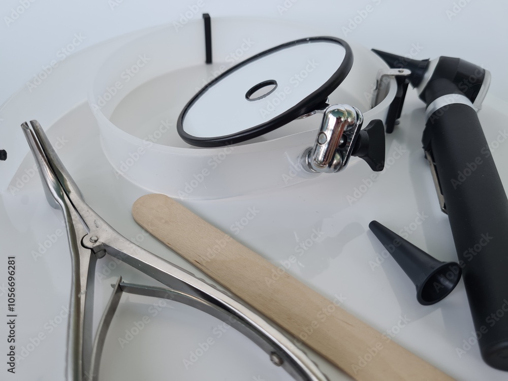 Round Doctors Instruments Medical tools arranged on a clean surface including a round mirror ...