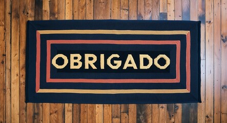 obrigado text on mat rug in wooden floor background