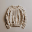 © Cozy Art - Beige cable-knit sweater on neutral background