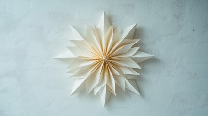 Round star shaped fold frame against a white wall