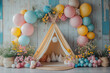 © KAMOSTOCK - A cheerful party setup featuring a teepee adorned with colorful balloons and flowers, creating a whimsical atmosphere for celebrations.