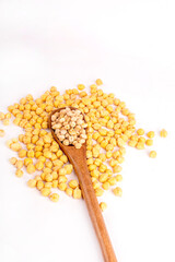 A bowl of chickpeas is on a white table