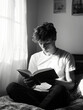 © Studio F. - Monochrome analogue image of a 16-year-old boy with brown hair reading a book
