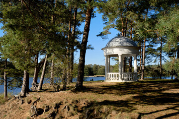 Classic white gazebo in tranquil park by lake