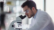 © Kornwit - A scientist in a lab developing nanomaterials under a microscope, working on innovations for various industries