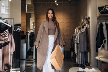 Happy facial expression. Woman chooses clothes in retail store