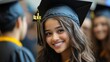 © addymawy - A young woman wearing a graduation cap smiles at the camera