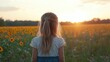 © Fadil - Child gazing at a sunset over a sunflower field.